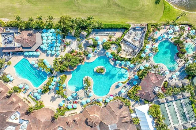 a view of a swimming pool with lawn chairs