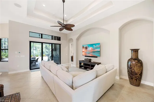 a living room with furniture a couch and a chandelier