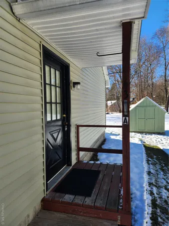 a view of a house with a door and wooden floor