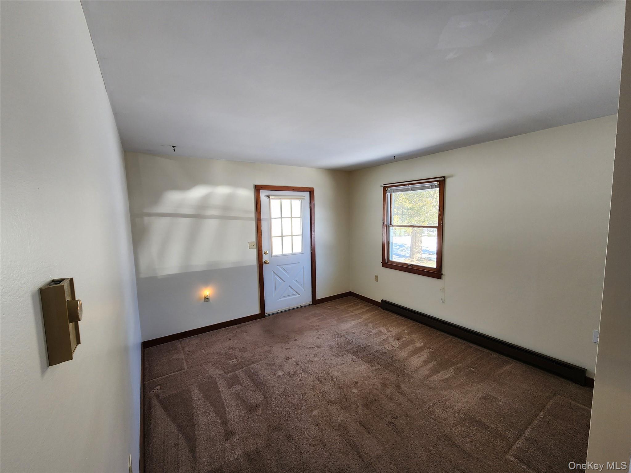 63 Jefferson Road, Unit A Red Hook, NY 12571 - Photo 3 of 13 a view of an empty room with a window and a kitchen