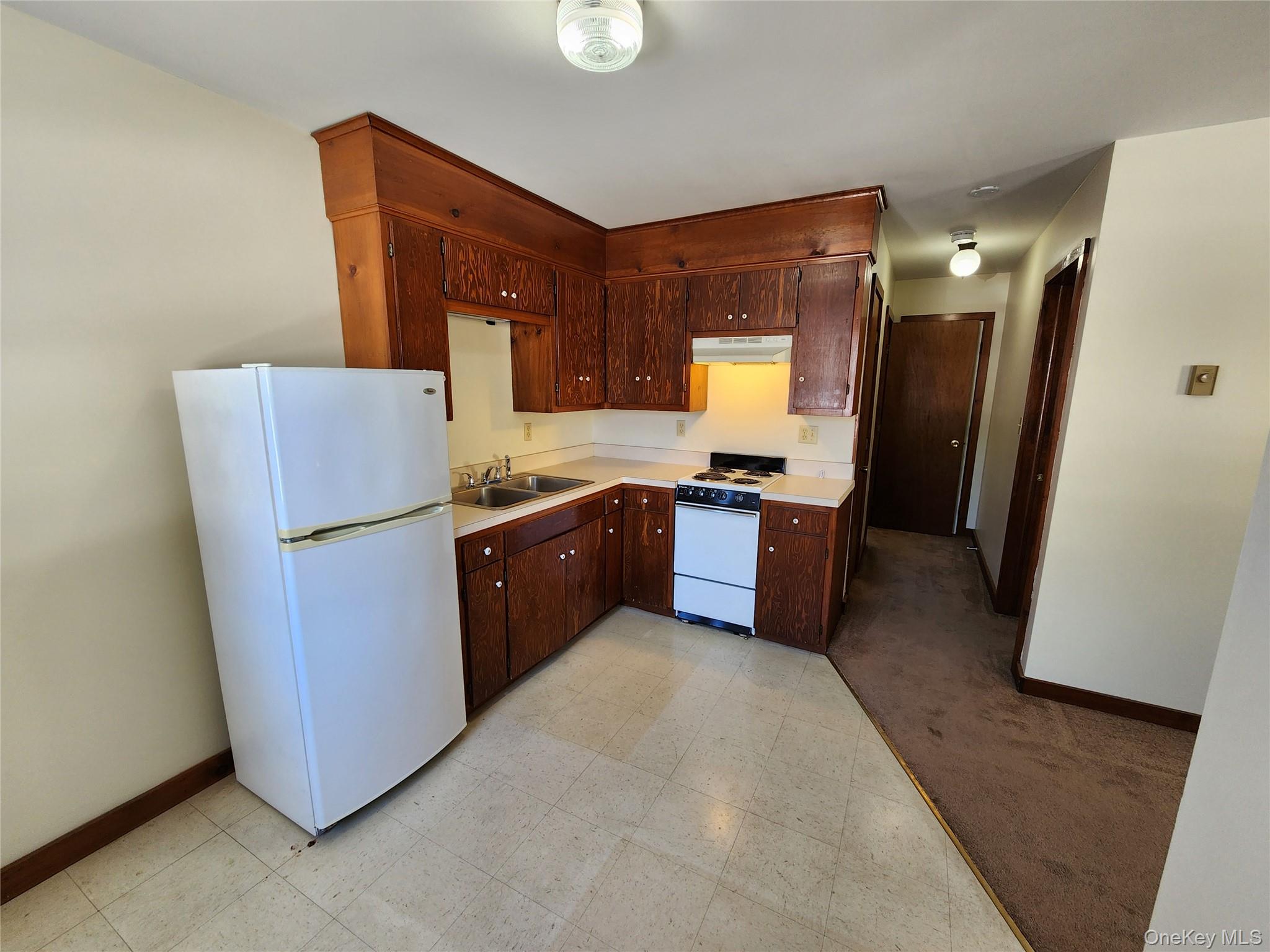 63 Jefferson Road, Unit A Red Hook, NY 12571 - Photo 5 of 13 a kitchen with sink cabinets and refrigerator