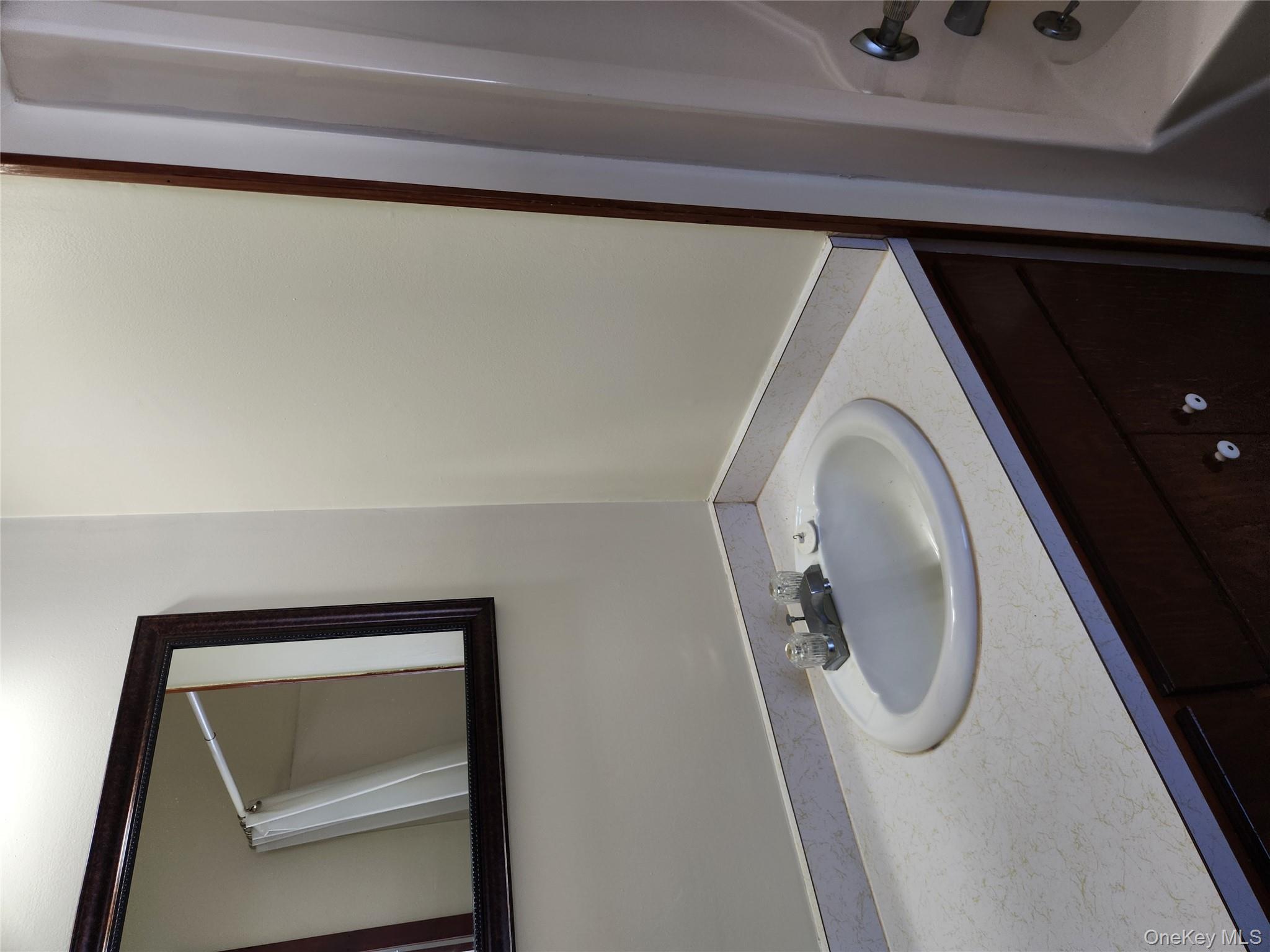 63 Jefferson Road, Unit A Red Hook, NY 12571 - Photo 8 of 13 a bathroom with a sink and a mirror