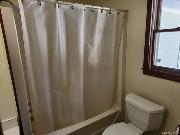 a bathroom with sink toilet and shower