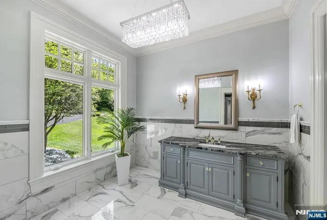 a large kitchen with kitchen island a large counter top space a sink stainless steel appliances and cabinets