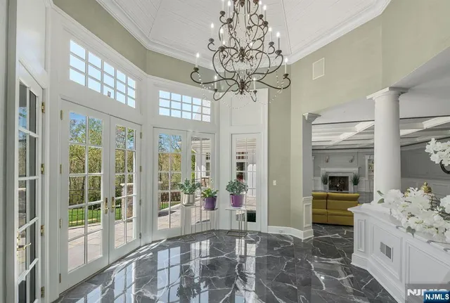 a large white kitchen with granite countertop a large window