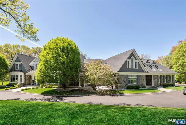 a front view of residential houses with yard and green space