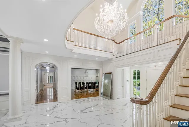 a view of a livingroom with wooden floor stairs
