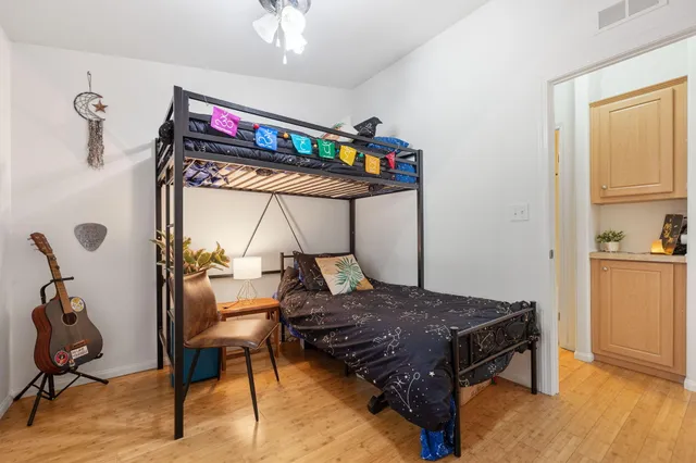a bedroom with a bed a desk and chair