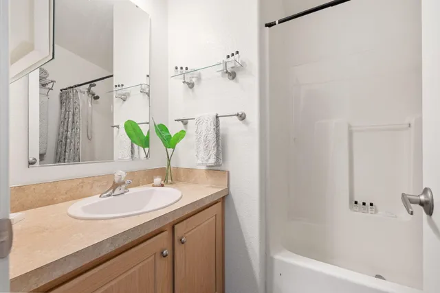a view of a patio with table and chairs with wooden floor and fence