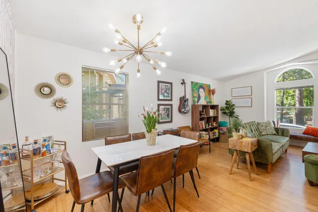 a view of a dining room with furniture and chandelier