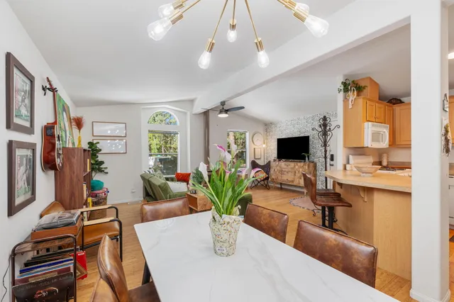 a view of a kitchen with dining table and chairs