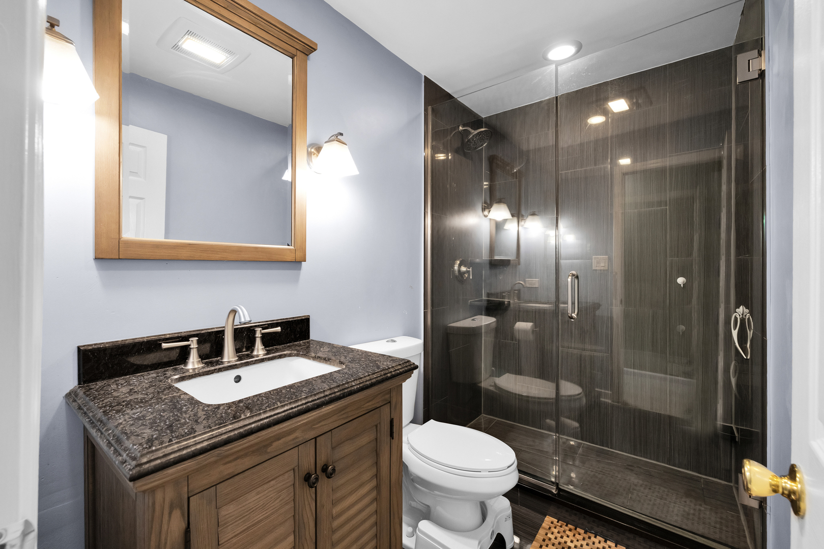 2245 West Nichols Road, Unit C Arlington Heights, IL 60004 - Photo 6 of 16 a bathroom with a granite countertop sink toilet and shower