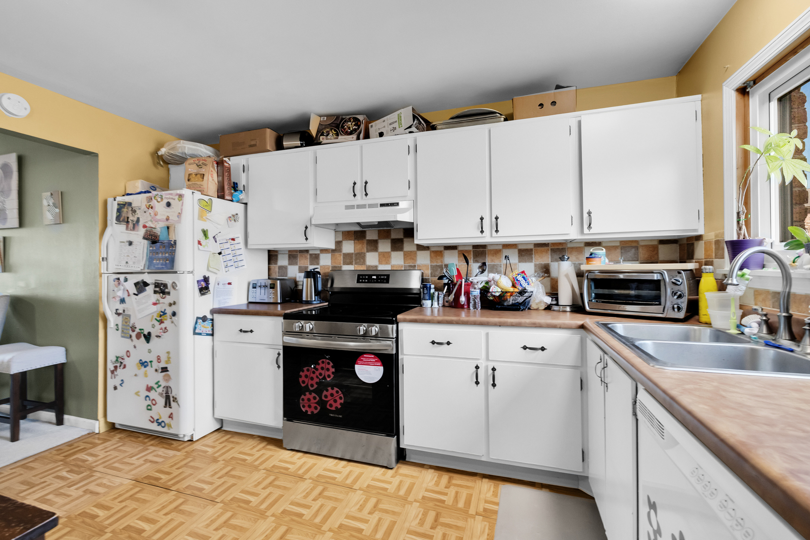 2245 West Nichols Road, Unit C Arlington Heights, IL 60004 - Photo 8 of 16 a kitchen with stainless steel appliances a refrigerator sink and cabinets