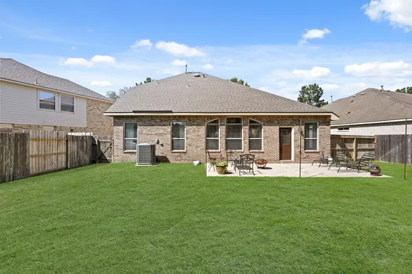 an aerial view of a house with outdoor space and a lake view