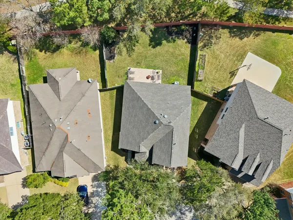 an aerial view of residential houses with outdoor space