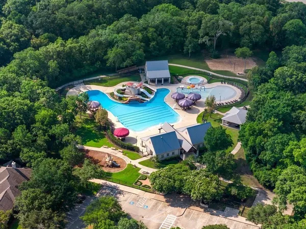 a swimming pool with outdoor seating and garden