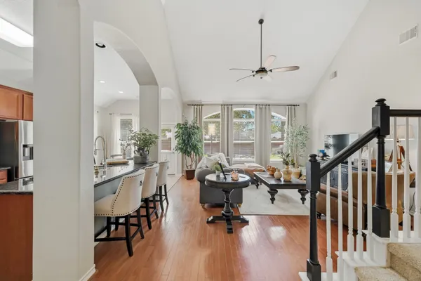 a view of a livingroom with furniture wooden floor windows and a chandelier