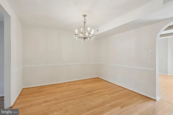 a view of a room with wooden floor and a window