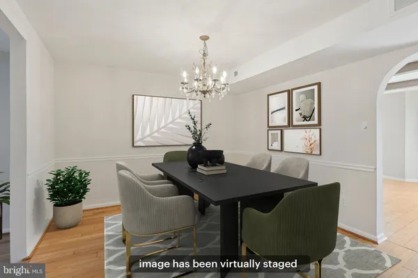 a view of a dining room with furniture and chandelier
