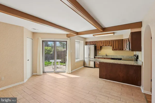 a view of a hallway with wooden floor and furniture