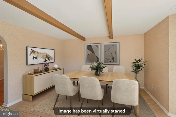 a dining room with furniture and a window