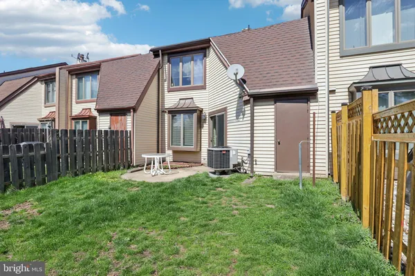 a front view of a house with yard and deck