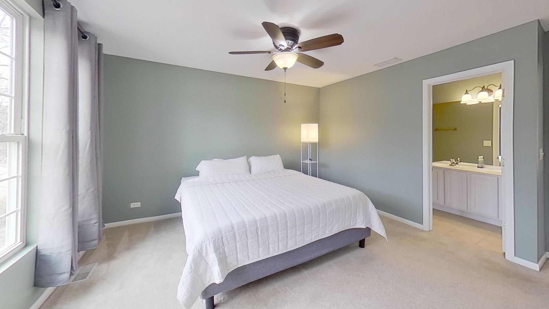 2418 Emily Lane Elgin, IL 60124 - Photo 11 of 27 a bedroom with a bed and a chandelier