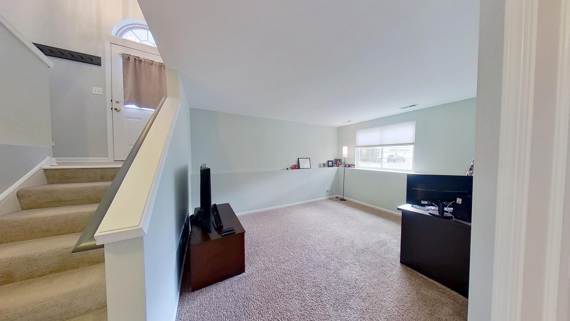 2418 Emily Lane Elgin, IL 60124 - Photo 16 of 27 a view of hallway with stairs and furniture