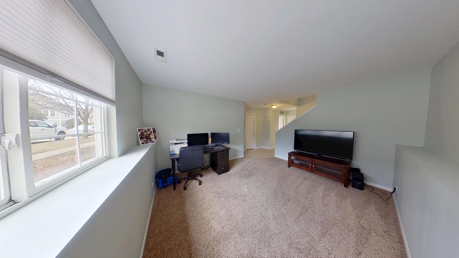 2418 Emily Lane Elgin, IL 60124 - Photo 18 of 27 a living room with furniture and a flat screen tv