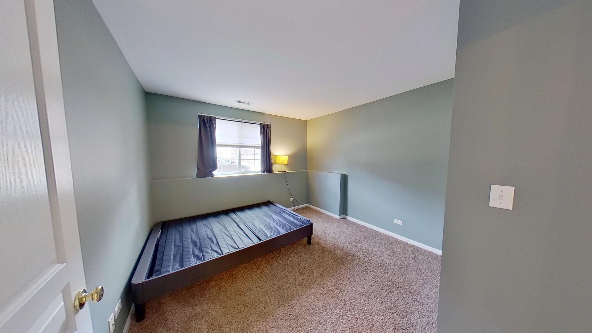2418 Emily Lane Elgin, IL 60124 - Photo 20 of 27 a view of an empty room with a window and wooden floor