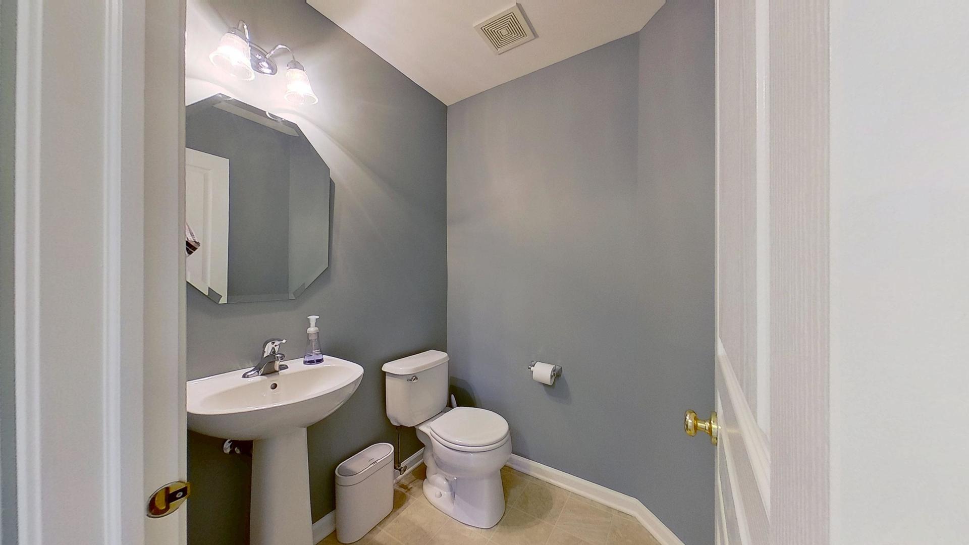 2418 Emily Lane Elgin, IL 60124 - Photo 22 of 27 a bathroom with a sink toilet and a mirror