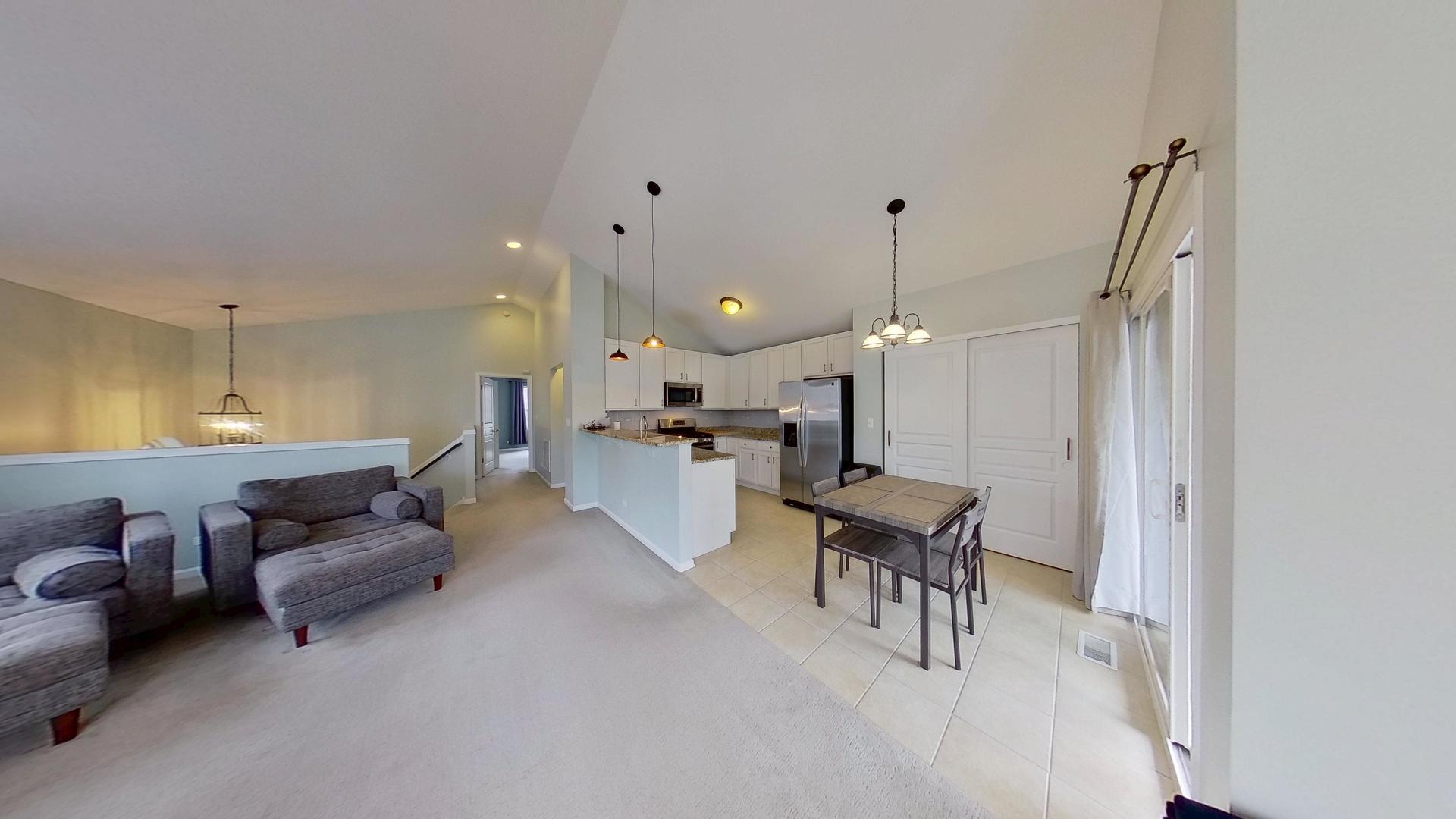 2418 Emily Lane Elgin, IL 60124 - Photo 5 of 27 a living room with furniture and kitchen view