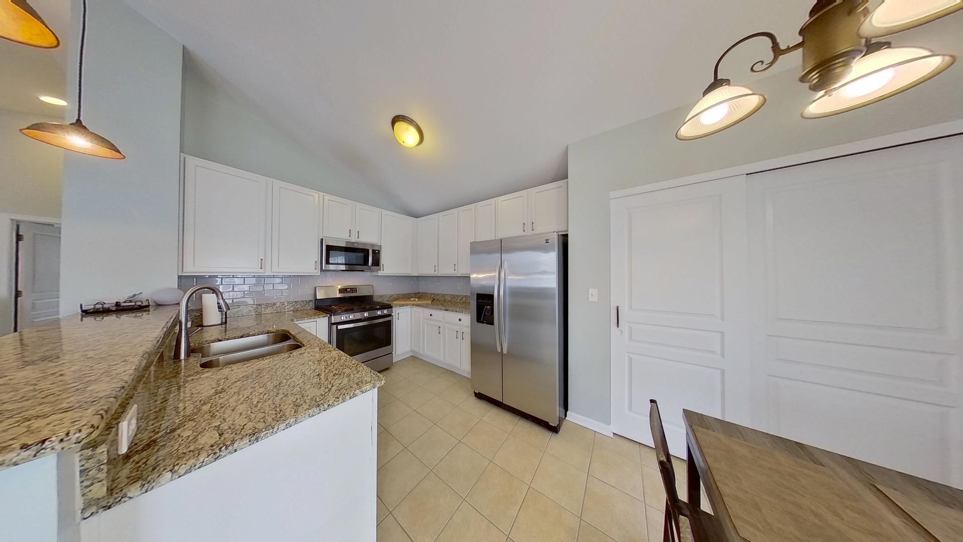 2418 Emily Lane Elgin, IL 60124 - Photo 6 of 27 a kitchen with refrigerator and window