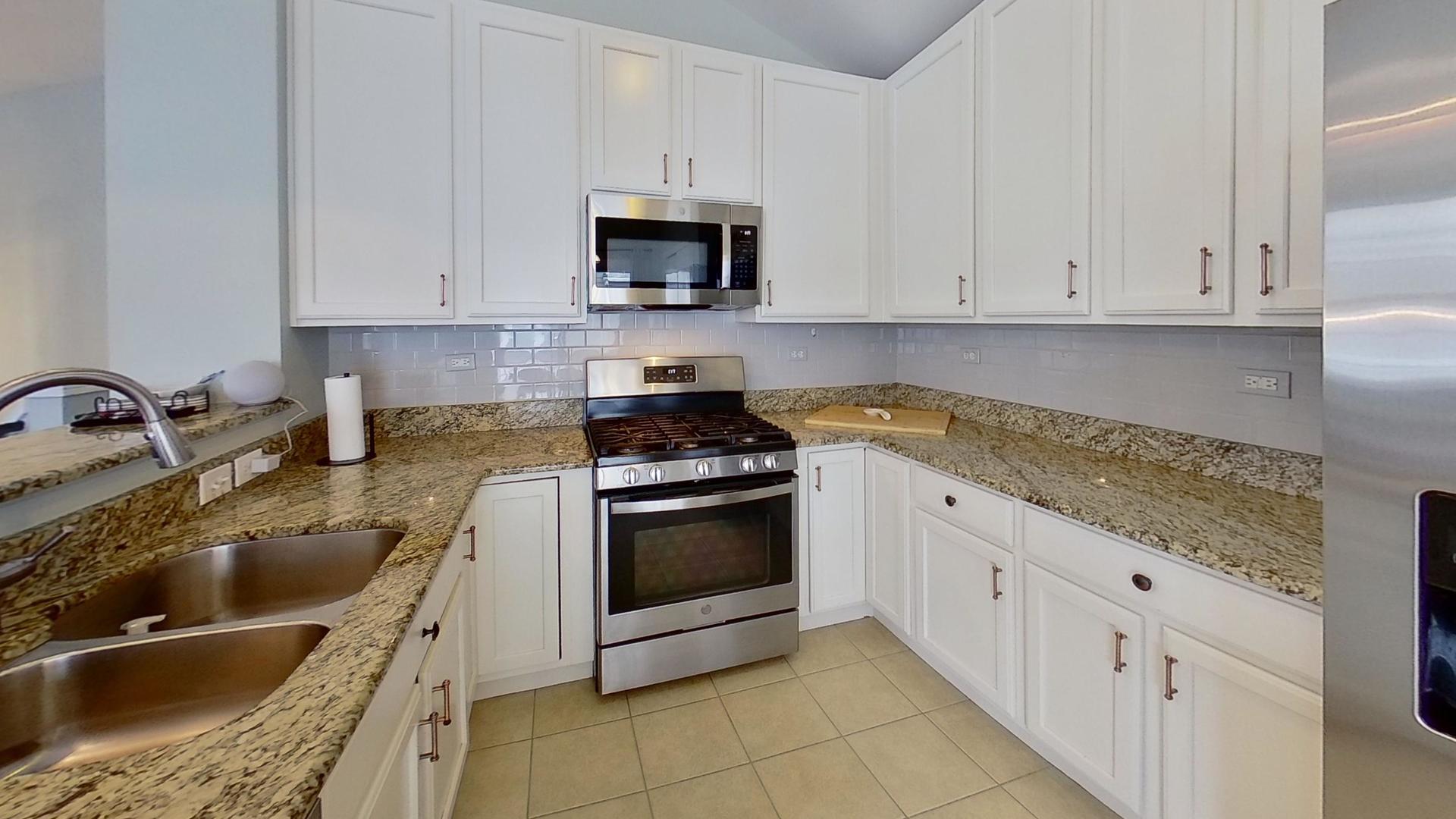 2418 Emily Lane Elgin, IL 60124 - Photo 8 of 27 a kitchen with granite countertop white cabinets and stainless steel appliances