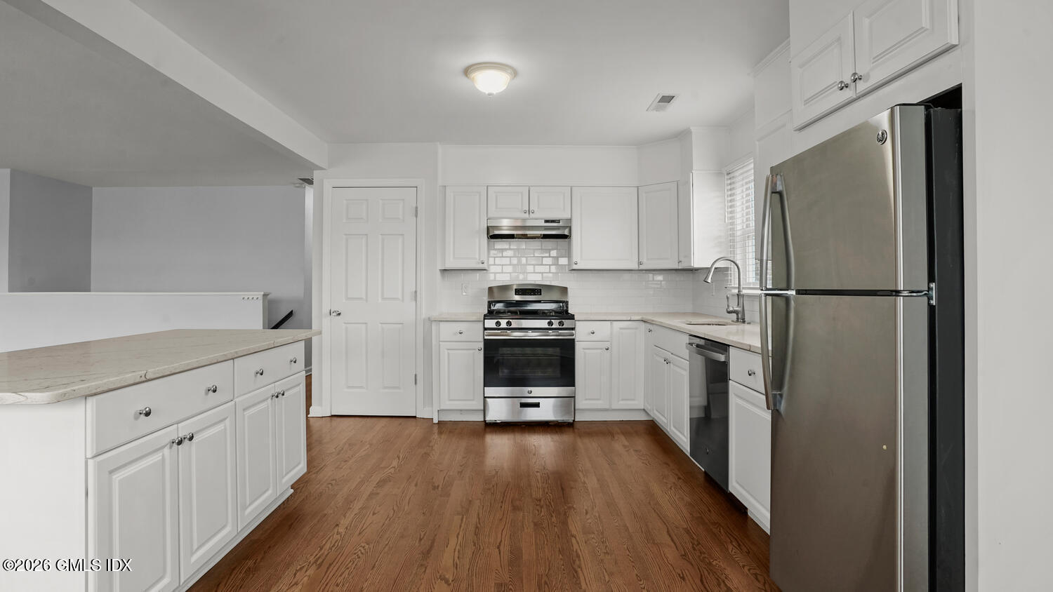 27 High Street, Unit B Greenwich, CT 06830 - Photo 3 of 19 a kitchen with a refrigerator a stove top oven and wooden floor
