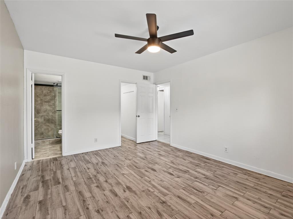 8400 West Sample Road, Unit 203 Coral Springs, FL 33065 - Photo 14 of 26 an empty room with wooden floor and windows