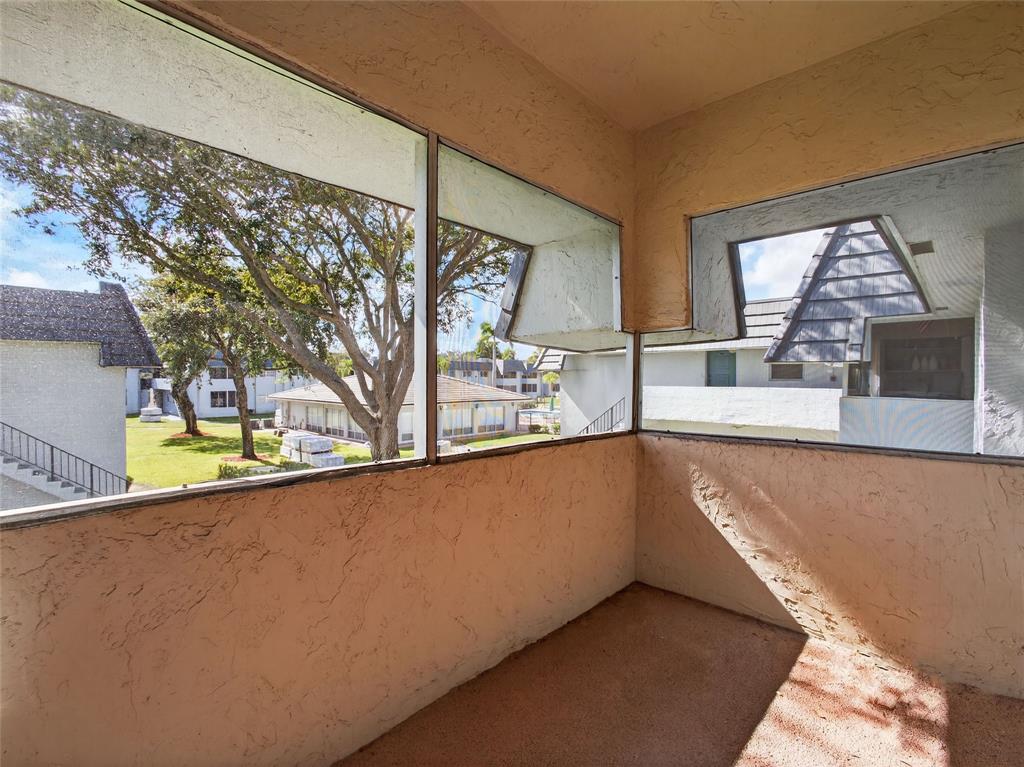 8400 West Sample Road, Unit 203 Coral Springs, FL 33065 - Photo 20 of 26 a view of a kitchen with a sink and a large window