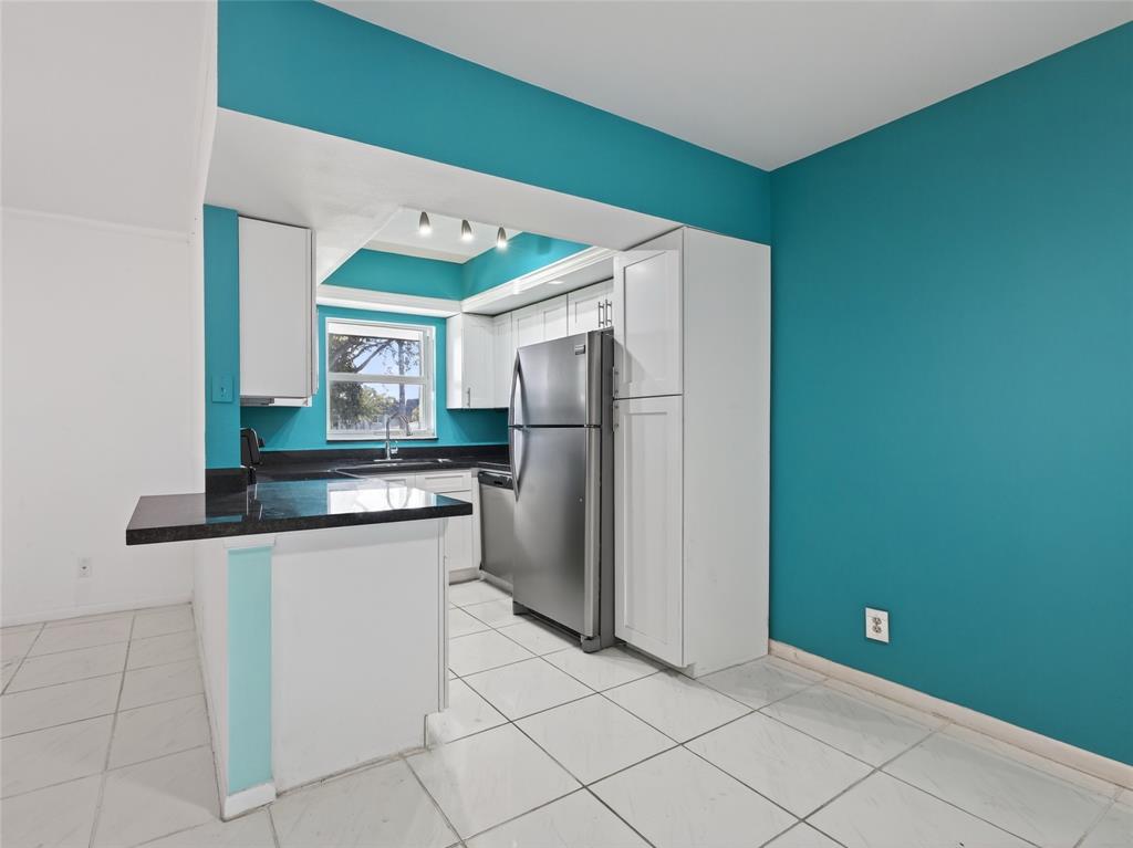 8400 West Sample Road, Unit 203 Coral Springs, FL 33065 - Photo 4 of 26 a kitchen with a refrigerator and a sink