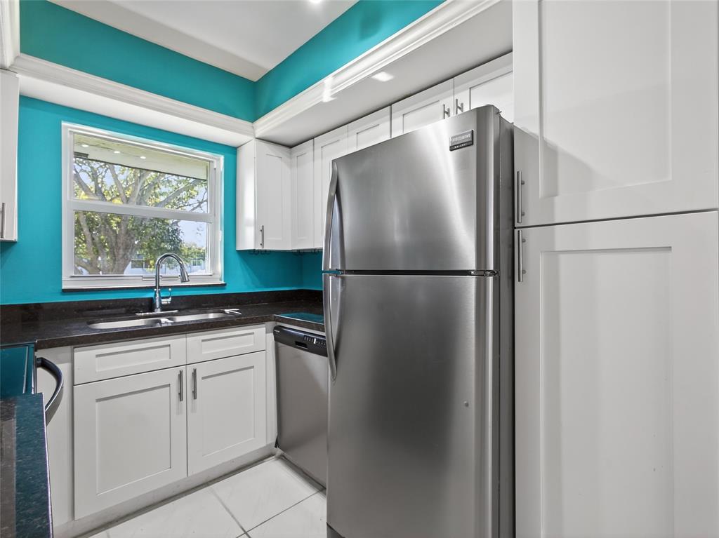8400 West Sample Road, Unit 203 Coral Springs, FL 33065 - Photo 6 of 26 a kitchen with stainless steel appliances granite countertop a refrigerator and a sink