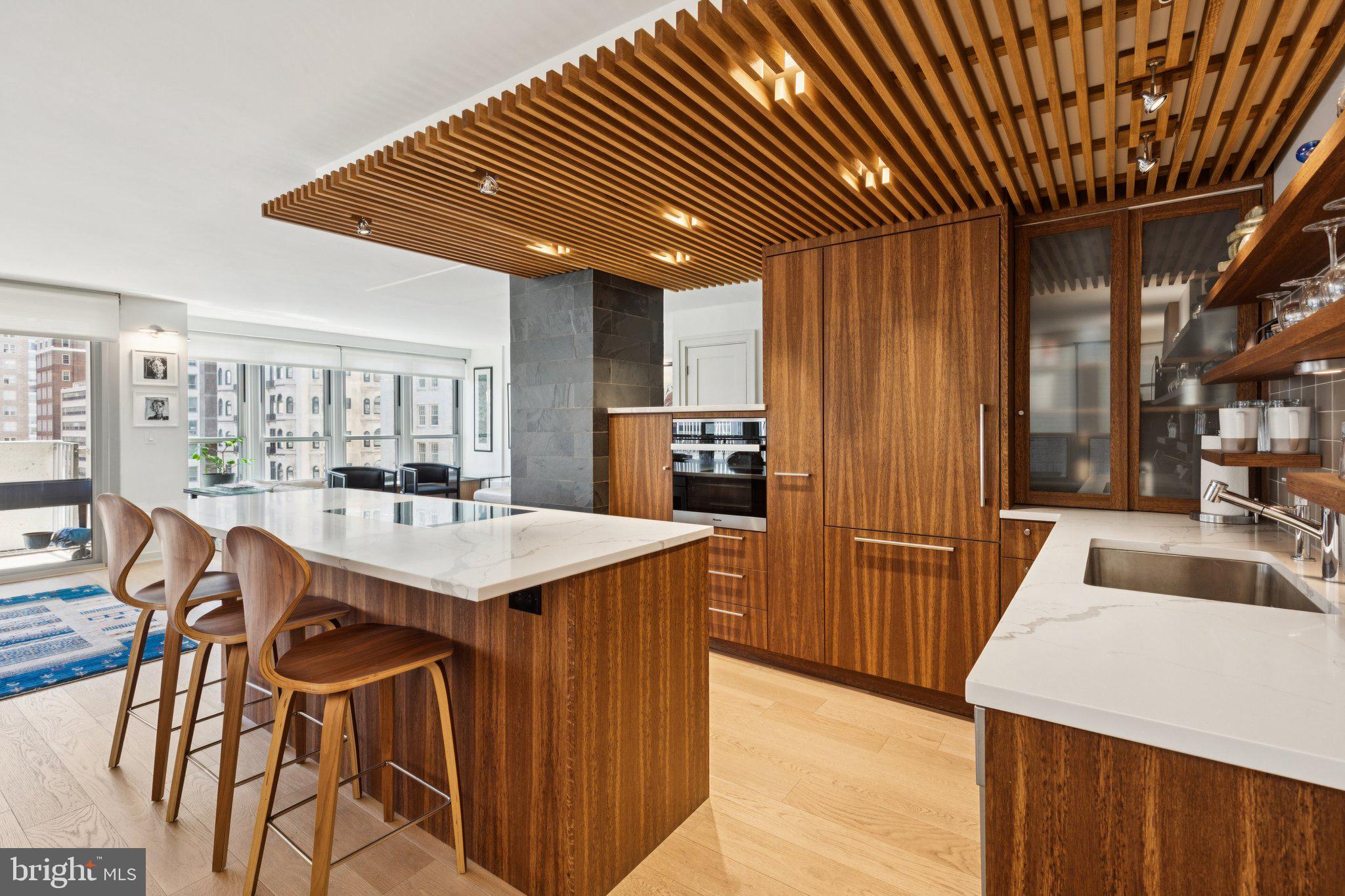 224 West Rittenhouse Square, Unit 1105 Philadelphia, PA 19103 - Photo 27 of 46 Sleek modern kitchen with warm wood tones.