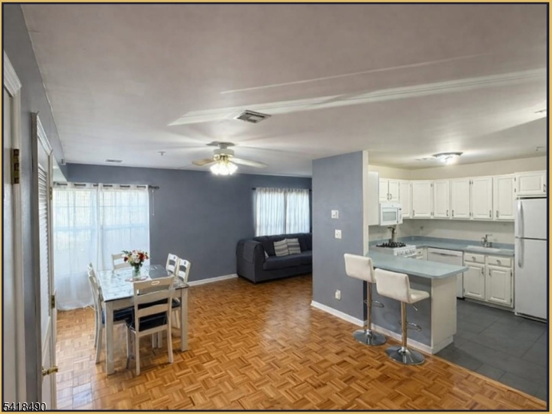 84 Union Street, Unit C2 Newark, NJ 07105 - Photo 4 of 13 a living room with stainless steel appliances kitchen island granite countertop furniture and a kitchen view