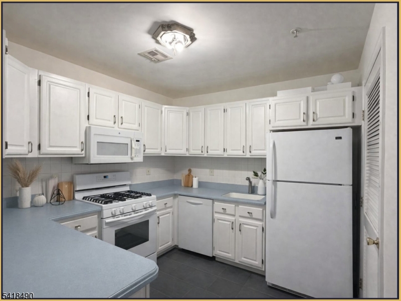 84 Union Street, Unit C2 Newark, NJ 07105 - Photo 6 of 13 a kitchen with cabinets stainless steel appliances and a counter