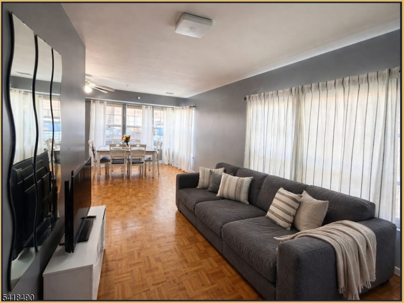 84 Union Street, Unit C2 Newark, NJ 07105 - Photo 7 of 13 a living room with furniture wooden floor and a large window