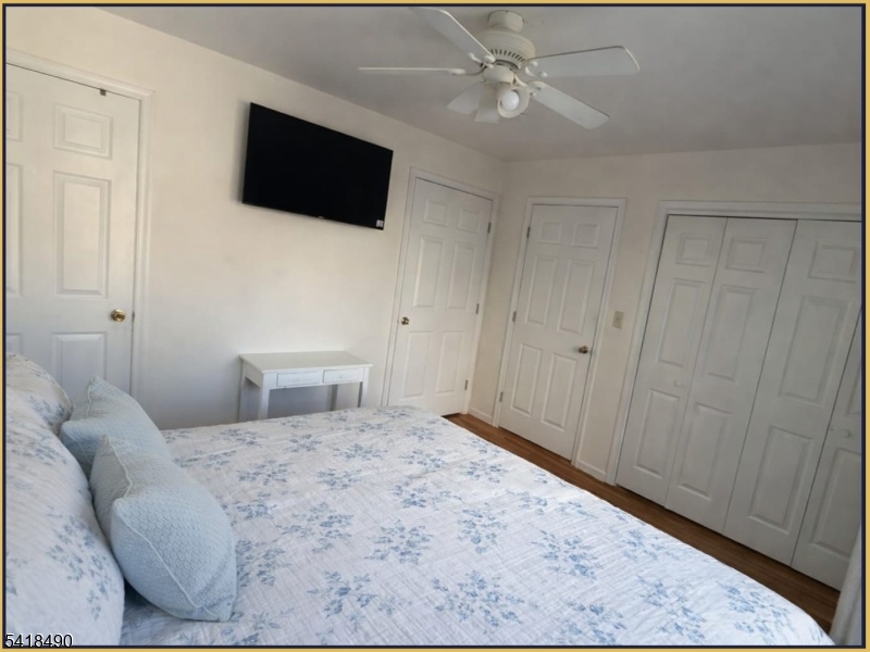 84 Union Street, Unit C2 Newark, NJ 07105 - Photo 9 of 13 a bedroom with a bed and a flat screen tv