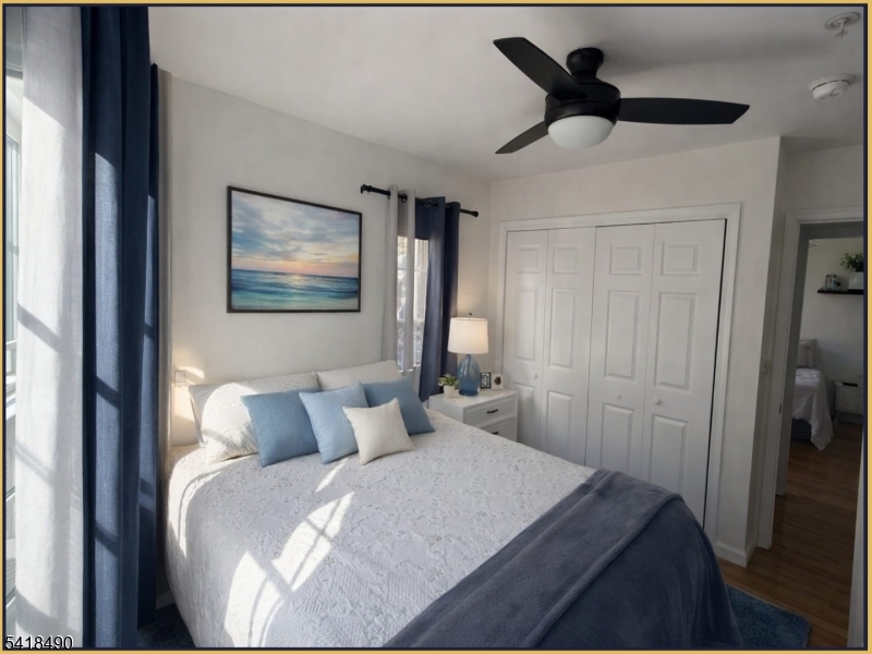 84 Union Street, Unit C2 Newark, NJ 07105 - Photo 10 of 13 a bedroom with a bed and a painting on the wall