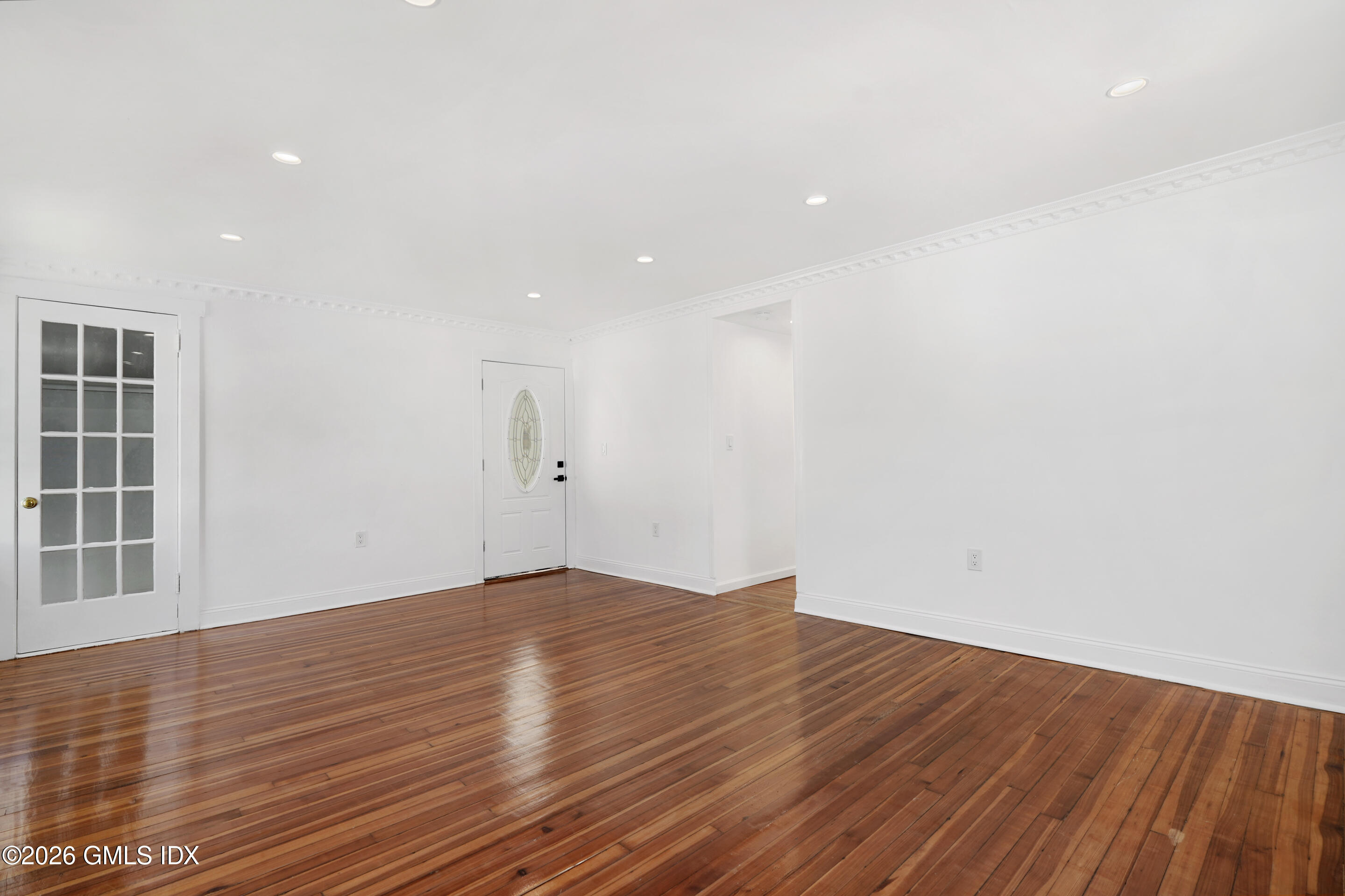 212 Davis Avenue, Unit B Greenwich, CT 06830 - Photo 5 of 10 a view of empty room with wooden floor and windows