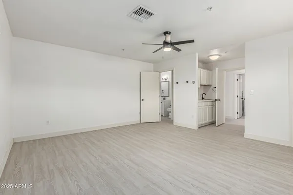 a view of a hallway with wooden shelves