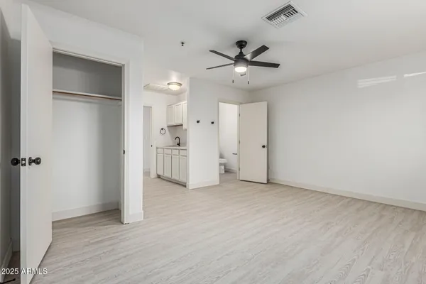 a kitchen with refrigerator a stove a sink and cabinets