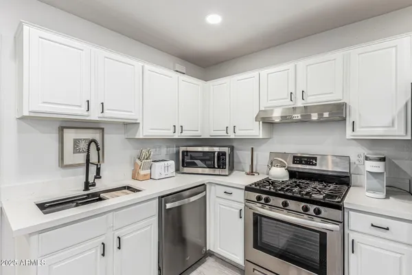 a living room with furniture a refrigerator and a stove