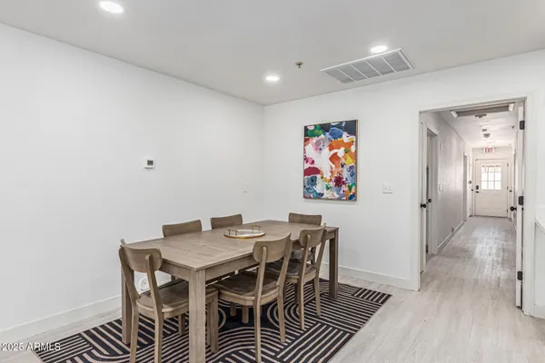 a kitchen with granite countertop a stove a sink and dishwasher with white cabinets